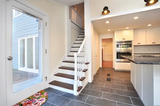 a view of a hallway with wooden floor and entryway