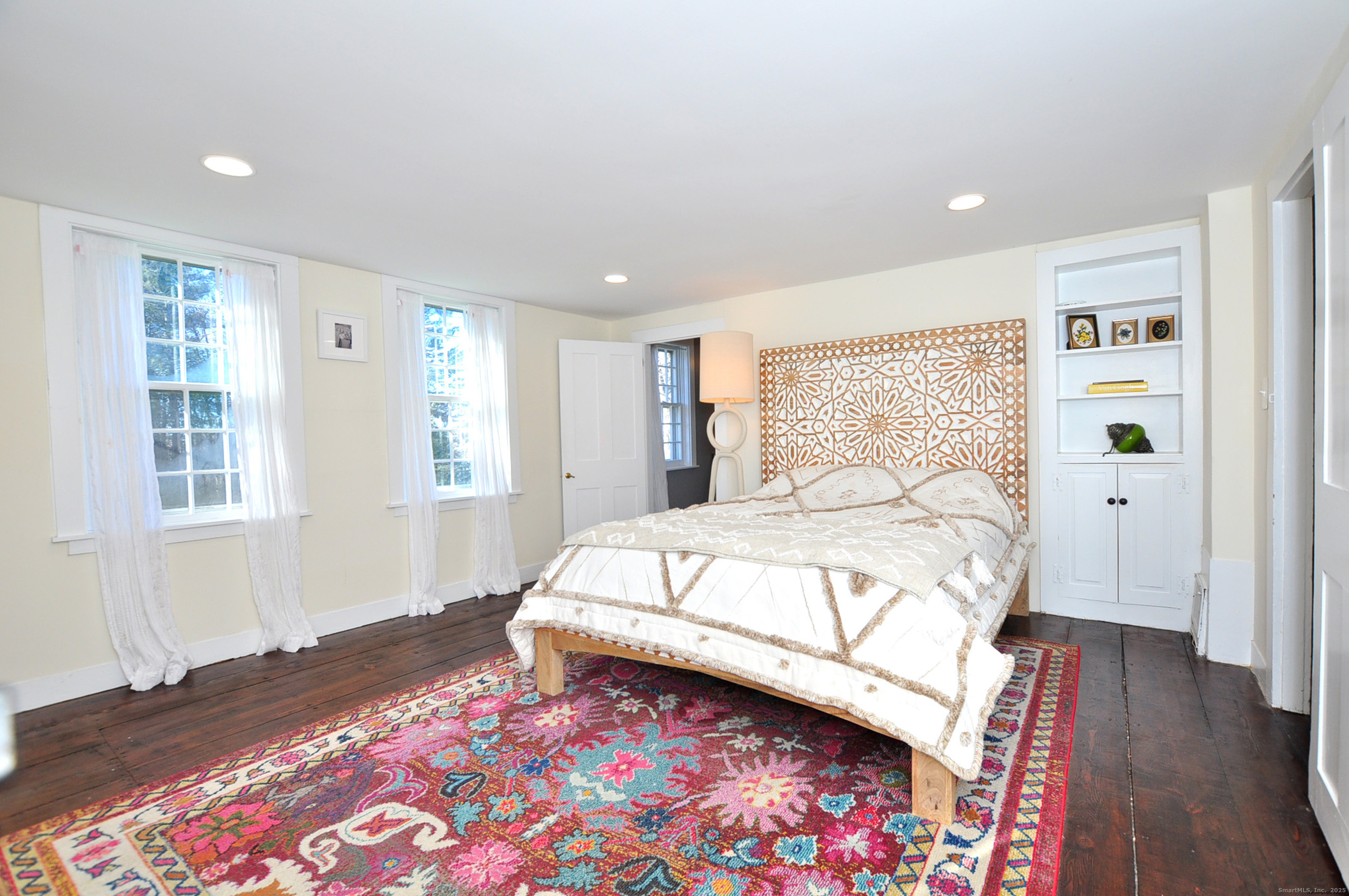11 West Chestnut Hill Road Litchfield, CT 06759 - Photo 24 of 39 a bedroom with a bed and wooden floor
