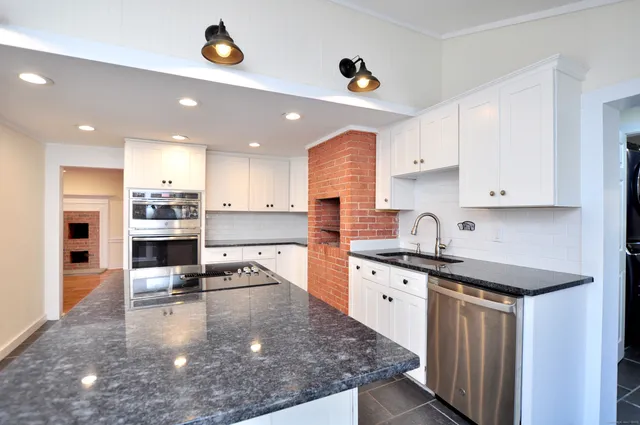 a kitchen with a sink stove and cabinets