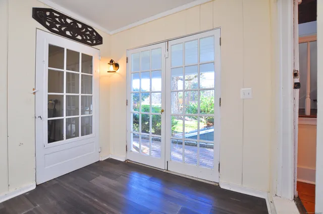 a view of wooden floor and windows in an empty room