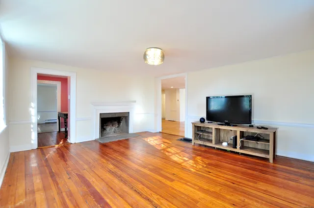 a view of a livingroom with furniture and a flat screen tv