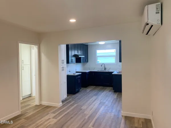 a kitchen with granite countertop a refrigerator and a stove top oven