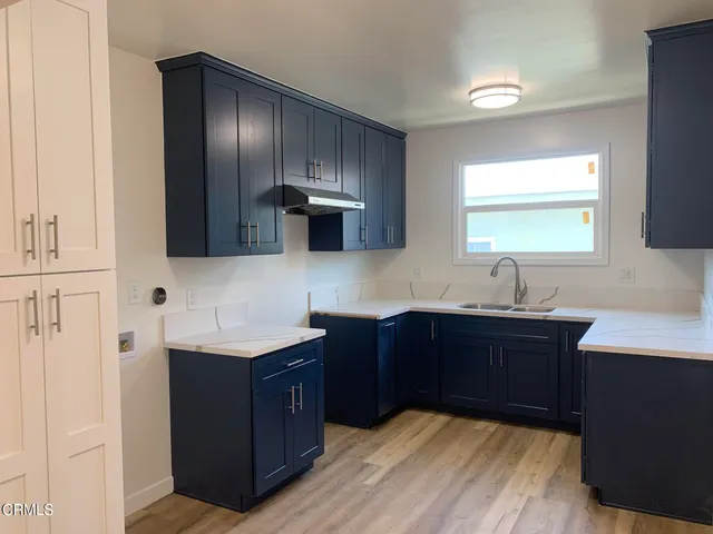 a kitchen with stainless steel appliances granite countertop a sink dishwasher stove and cabinets