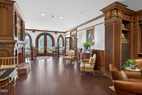 a living room with furniture a fireplace and wooden floor