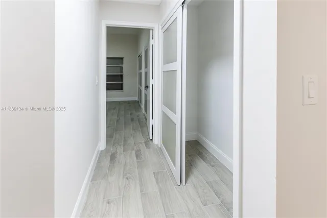 a view of a hallway with wooden floor