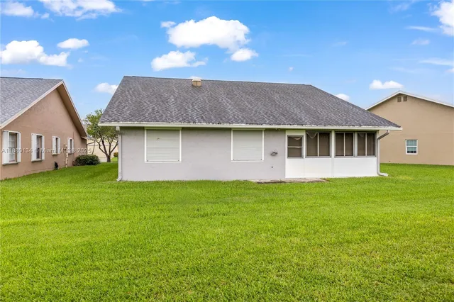 a view of a house with a backyard