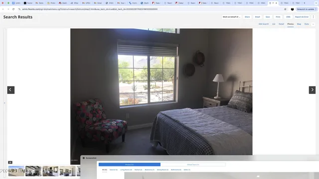 a living room with a couch and a dresser with wooden floor