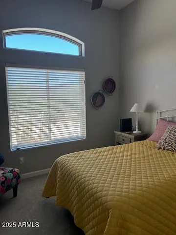 a bedroom with a bed and window