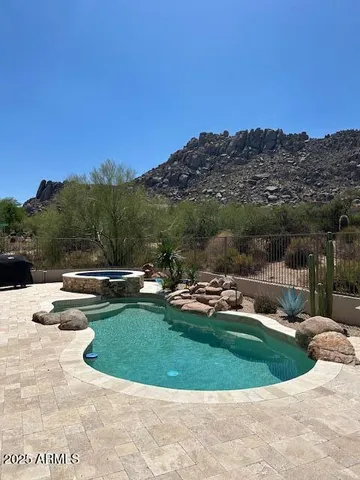 a view of a swimming pool and mountains