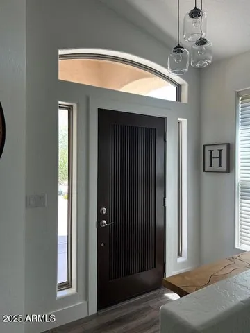 a view of a livingroom with a window and chandelier