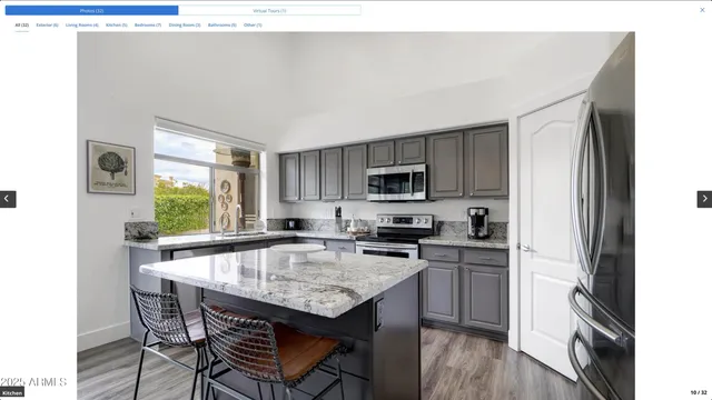 a kitchen with stainless steel appliances granite countertop a stove top oven a sink dishwasher and cabinets with wooden floor