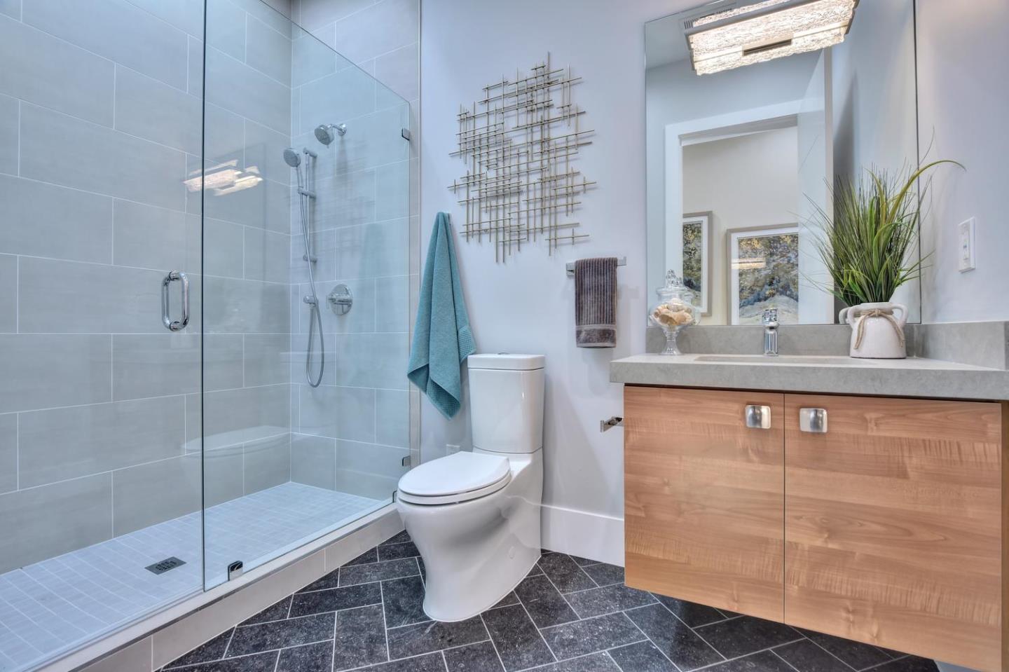 978 Covington Road Los Altos, CA 94024 - Photo 35 of 39 a bathroom with a granite countertop sink a toilet and shower