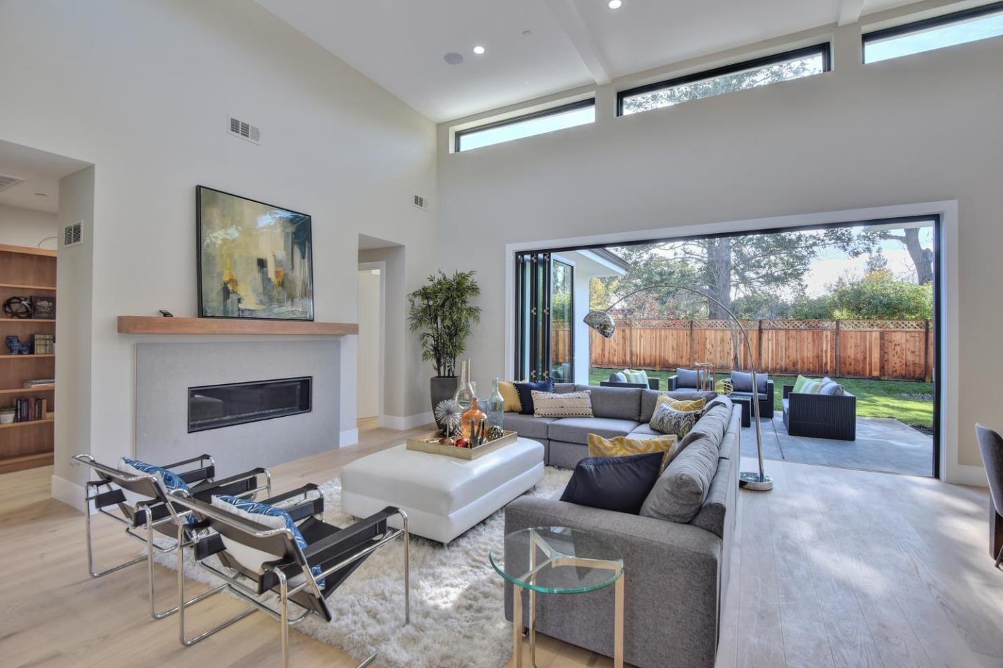 978 Covington Road Los Altos, CA 94024 - Photo 7 of 39 a living room with furniture a fireplace and a floor to ceiling window