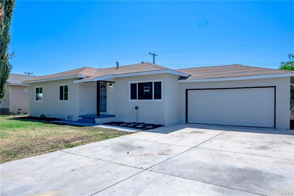 10580 Cook Avenue Riverside, CA 92505 - Photo 1 of 1 a front view of a house with a garage