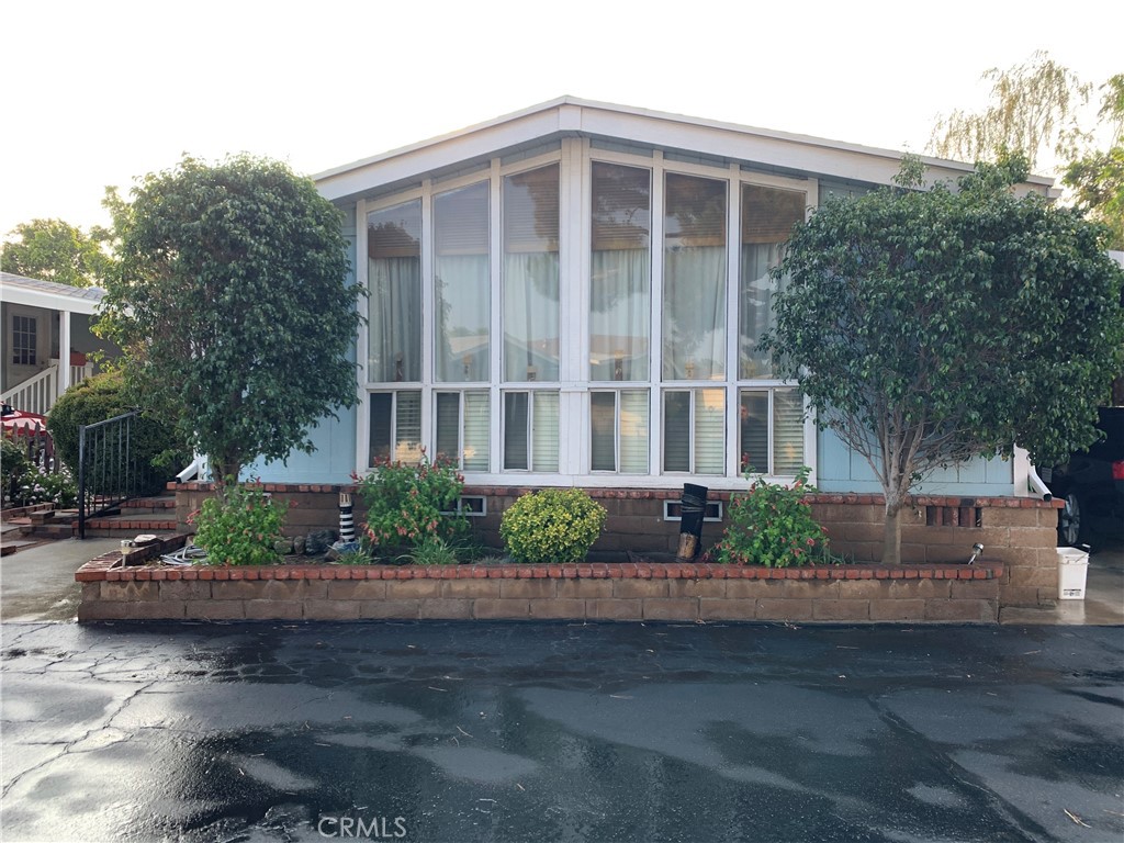 8651 Foothill Boulevard, Unit 99 Rancho Cucamonga, CA 91730 - Photo 1 of 1 a front view of a house with a garden