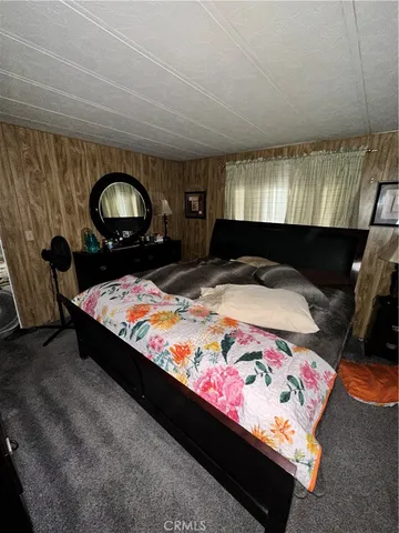 a bed sitting in a bedroom next to a window