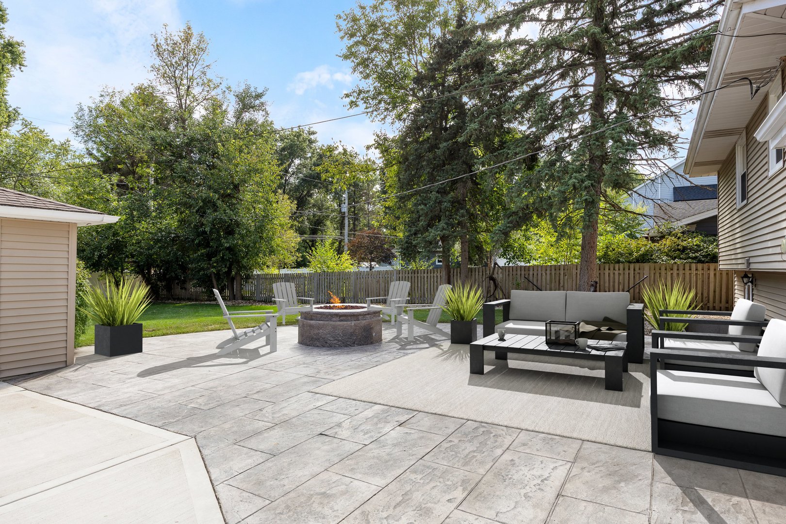 132 Robin Hill Drive Naperville, IL 60540 - Photo 12 of 29 a view of a patio with dining table and chairs with a fire pit