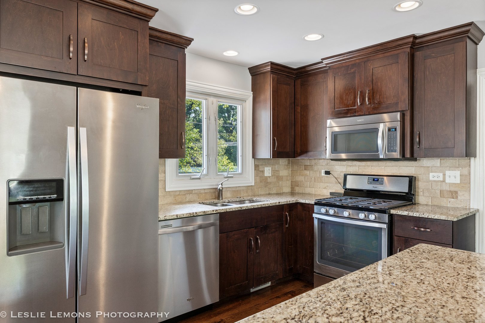 132 Robin Hill Drive Naperville, IL 60540 - Photo 14 of 29 a kitchen with granite countertop a refrigerator stove and microwave