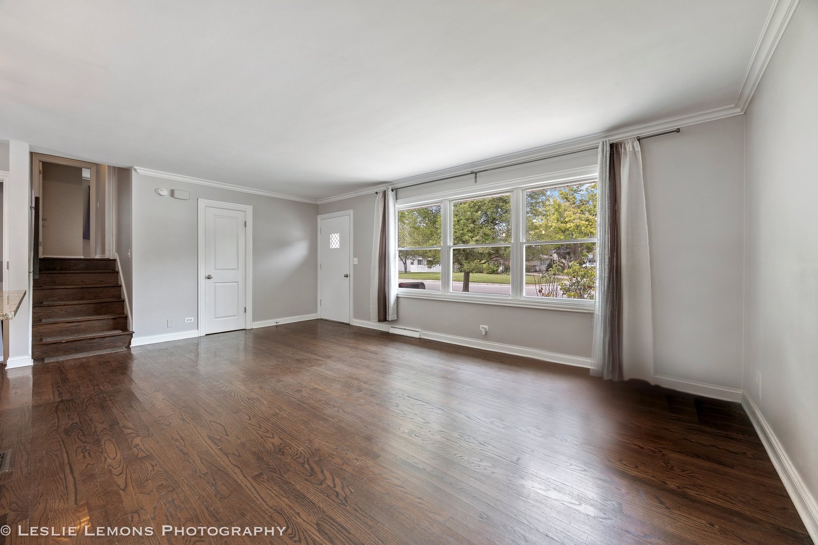 132 Robin Hill Drive Naperville, IL 60540 - Photo 19 of 29 a view of an empty room with wooden floor and a window