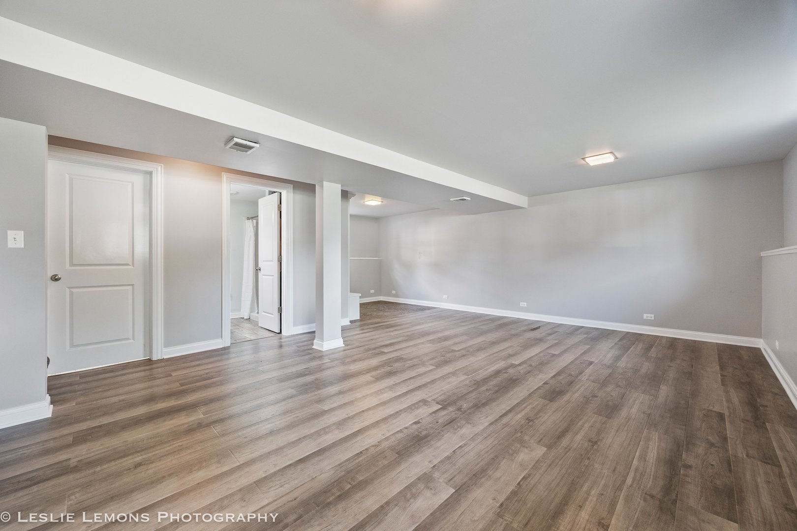 132 Robin Hill Drive Naperville, IL 60540 - Photo 24 of 29 a view of an empty room with wooden floor