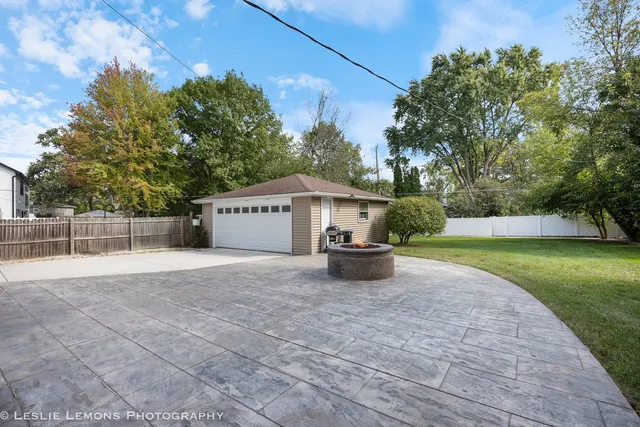 a view of a house with backyard and a tree