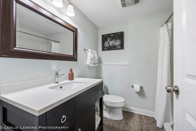 a bathroom with a sink mirror and toilet