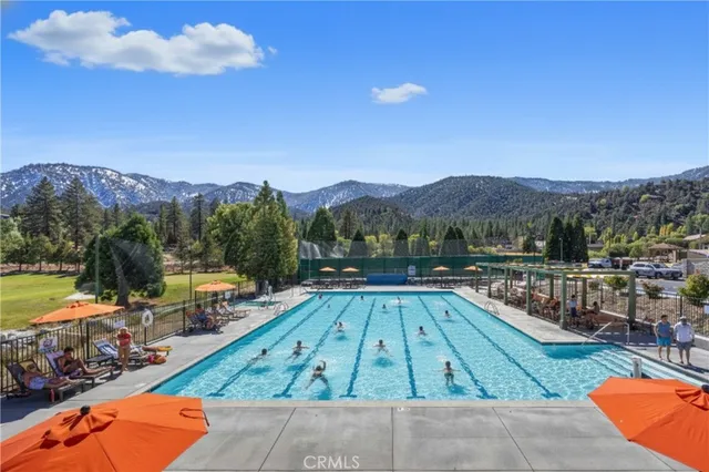 a view of a swimming pool with a table and chairs
