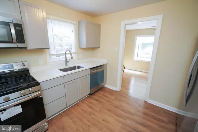 a kitchen with a sink stove and cabinets