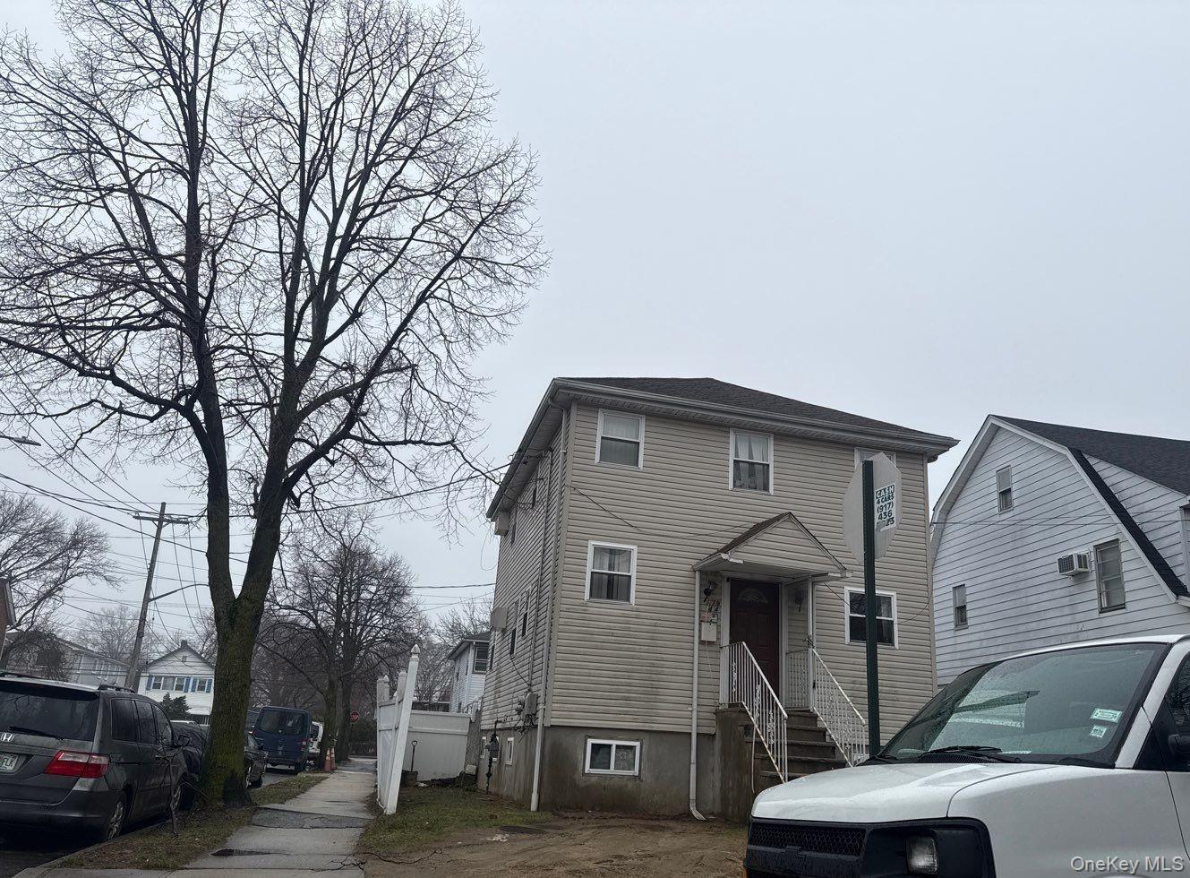 179-44 143rd Road Queens, NY 11434 - Photo 3 of 4 a front view of a house with parking space