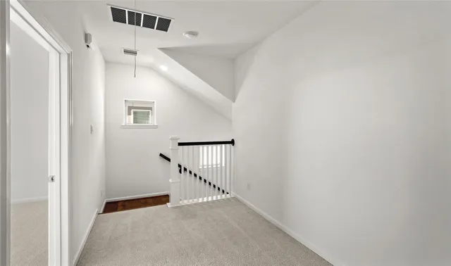 a view of a hallway with staircase