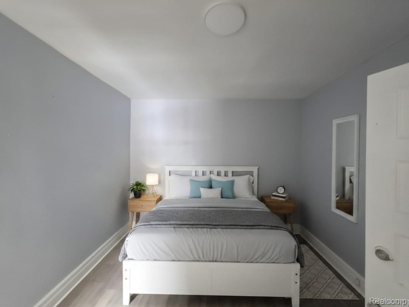 3801 Ellery Street Detroit, MI 48207 - Photo 8 of 8 Room featuring light gray wall paint, wood-finish flooring, white baseboards, and a flush-mount ceiling light