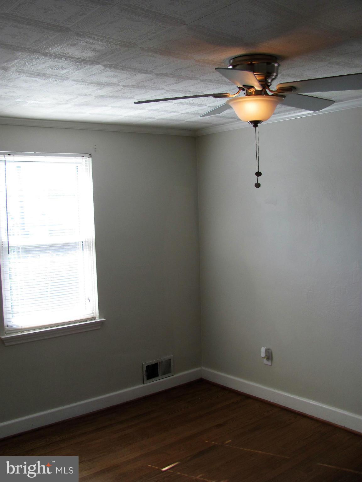 8528 Water Oak Road Baltimore, MD 21234 - Photo 14 of 30 a view of a small space with wooden floor and a window