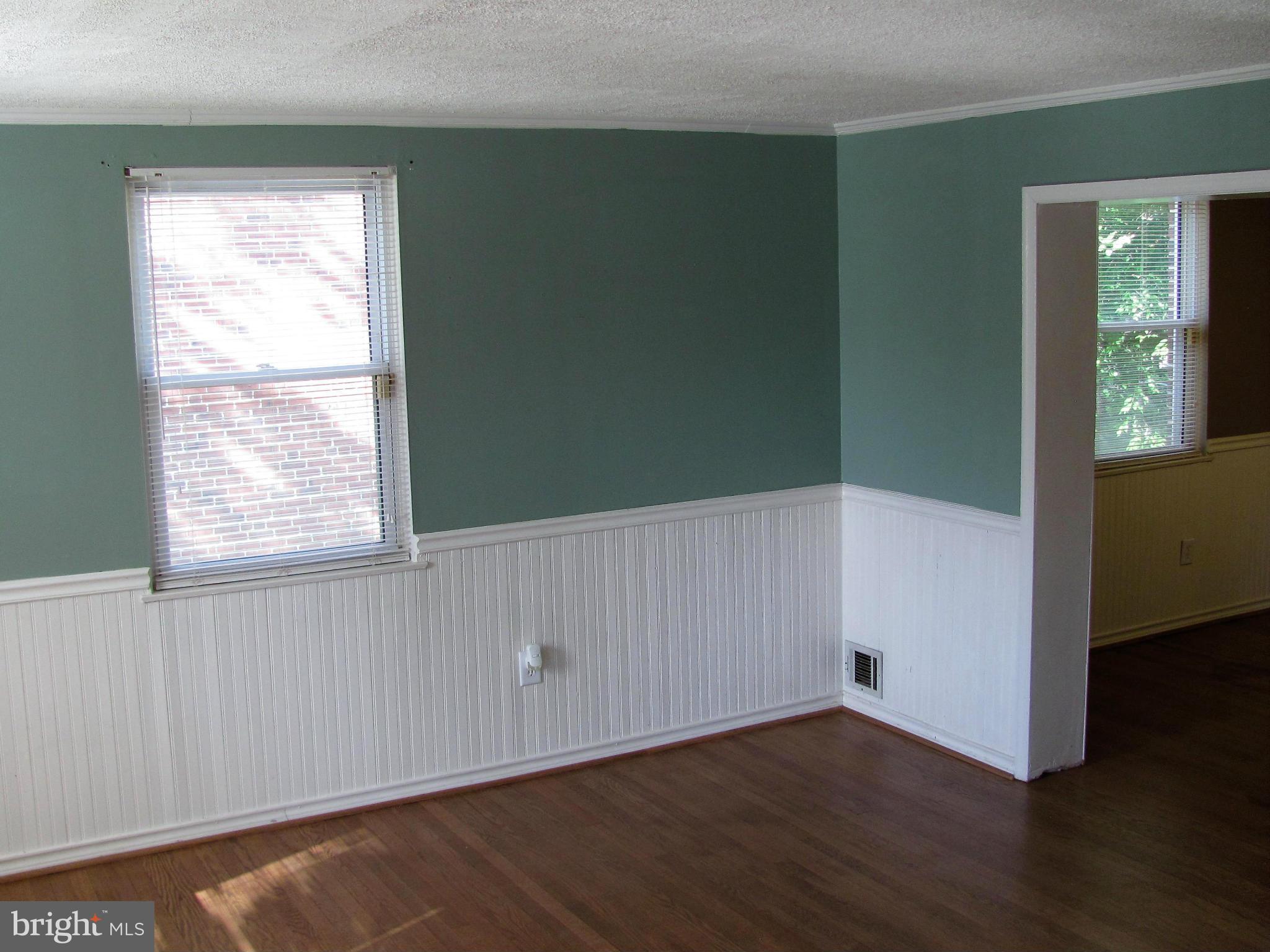 8528 Water Oak Road Baltimore, MD 21234 - Photo 3 of 30 an empty room with wooden floor and windows