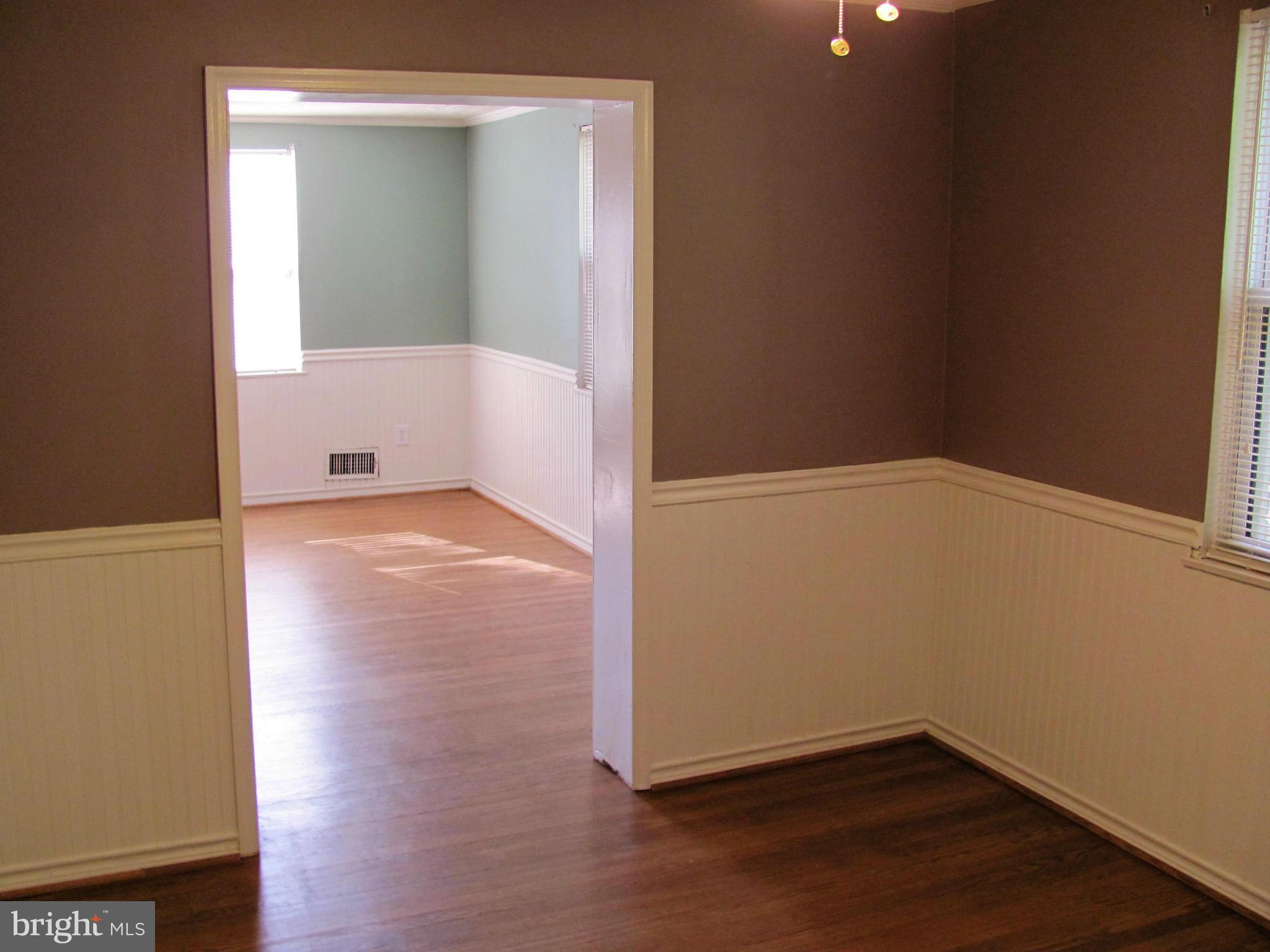 8528 Water Oak Road Baltimore, MD 21234 - Photo 8 of 30 an empty room with wooden floor and windows