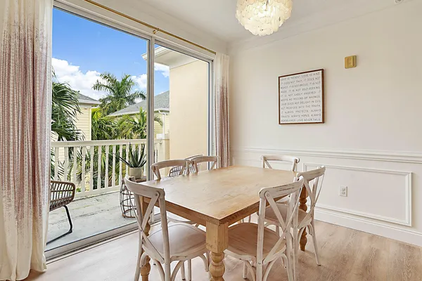 a view of a dining room with furniture large windows and wooden floor