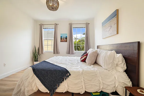 a bedroom with a bed and painting on the wall