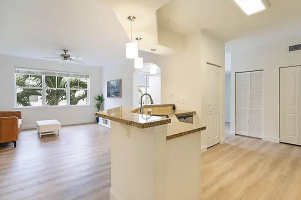 a spacious bathroom with a granite countertop sink and a mirror