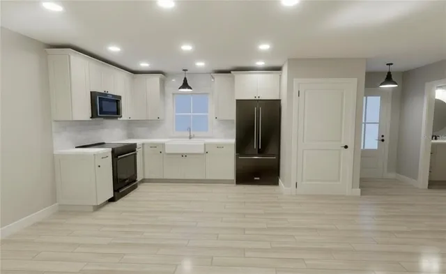 a view of a kitchen with a sink and a refrigerator