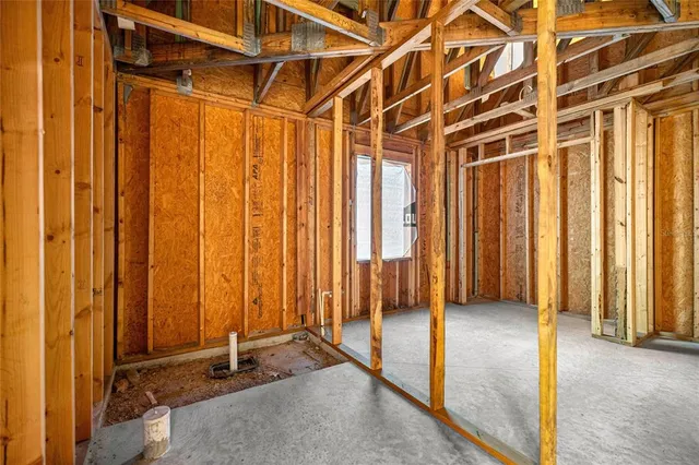 a view of a room with a wooden door and door