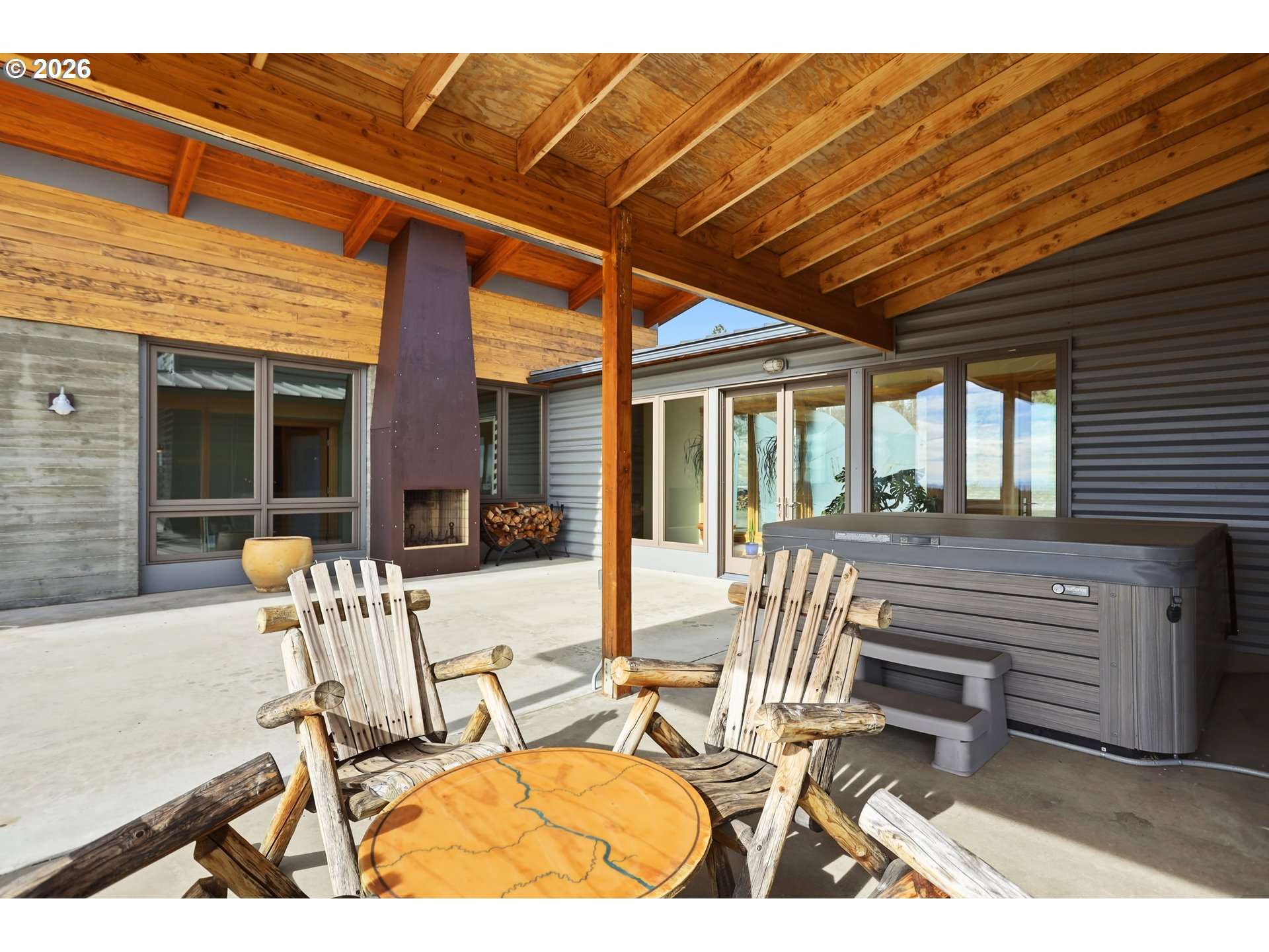 505 Knight Road Goldendale, WA 98620 - Photo 29 of 48 a view of a patio with table and chairs with wooden floor and fence