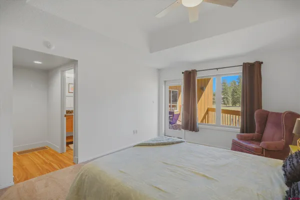 a bedroom with a bed and glass window
