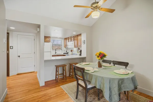 a view of a dining room with furniture and wooden floor