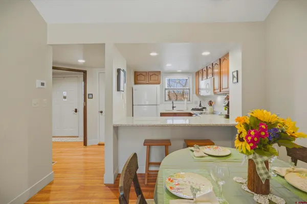 a kitchen with granite countertop a white cabinets and potted plant