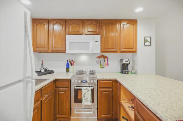 a kitchen with stainless steel appliances granite countertop a sink stove and cabinets