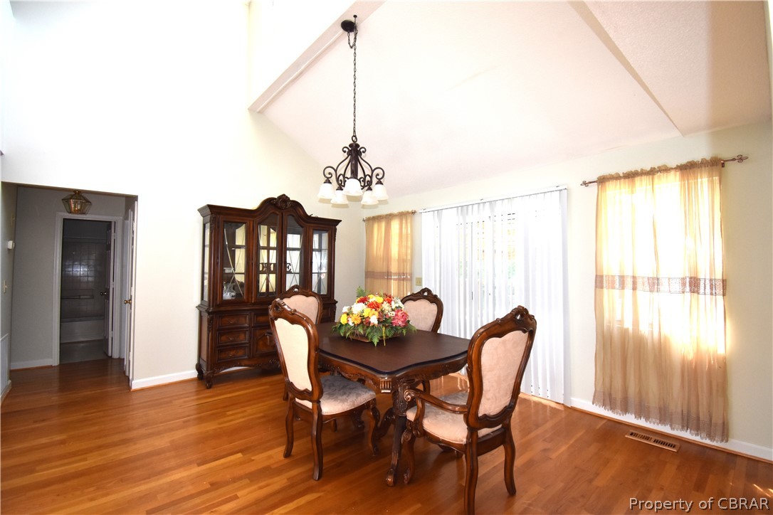 151 Thomas Landing Road Lancaster, VA 22503 - Photo 21 of 39 a view of a dining room with furniture window and wooden floor