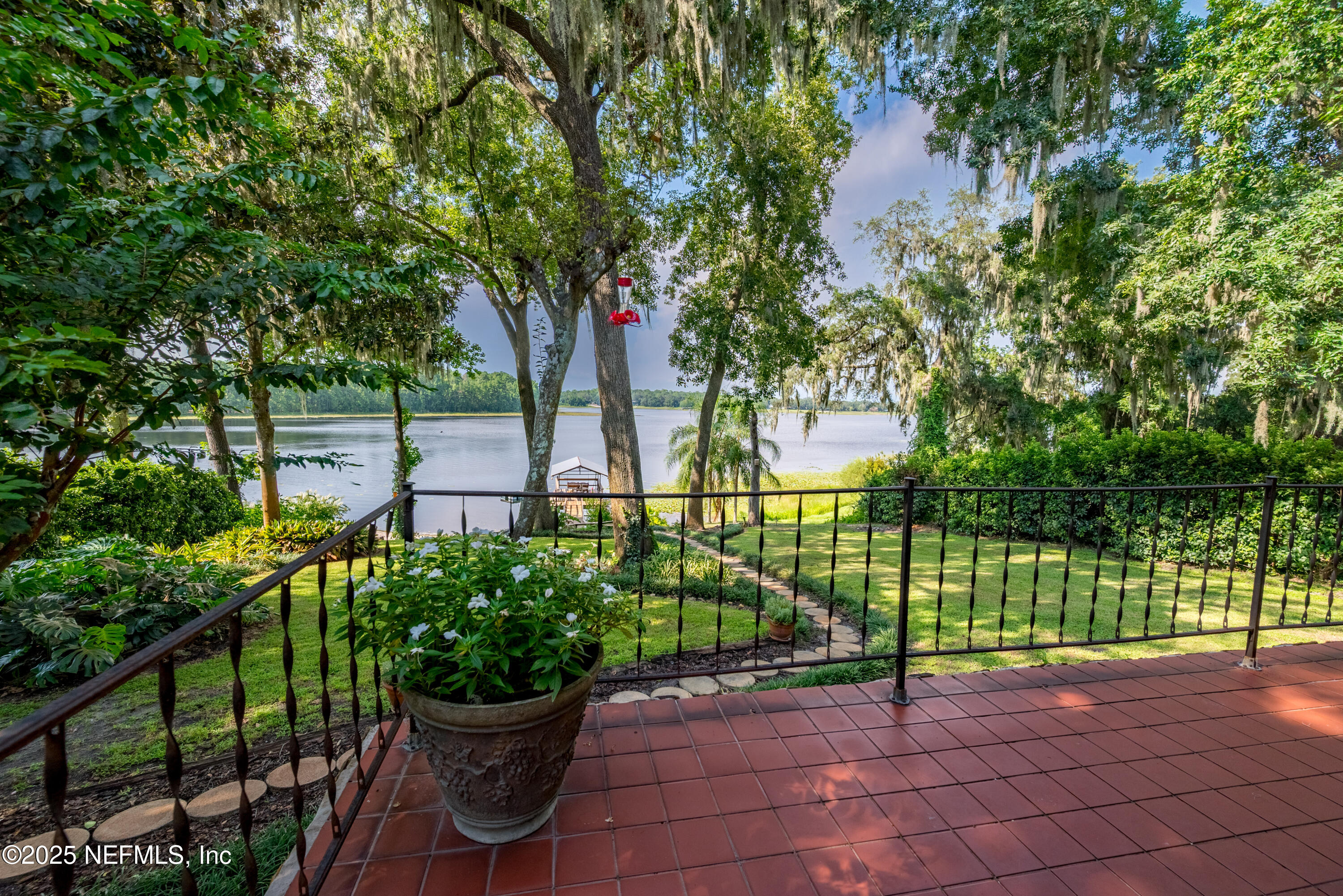 8166 Alderman Road Melrose, FL 32666 - Photo 11 of 94 a view of a backyard with plants and lake view