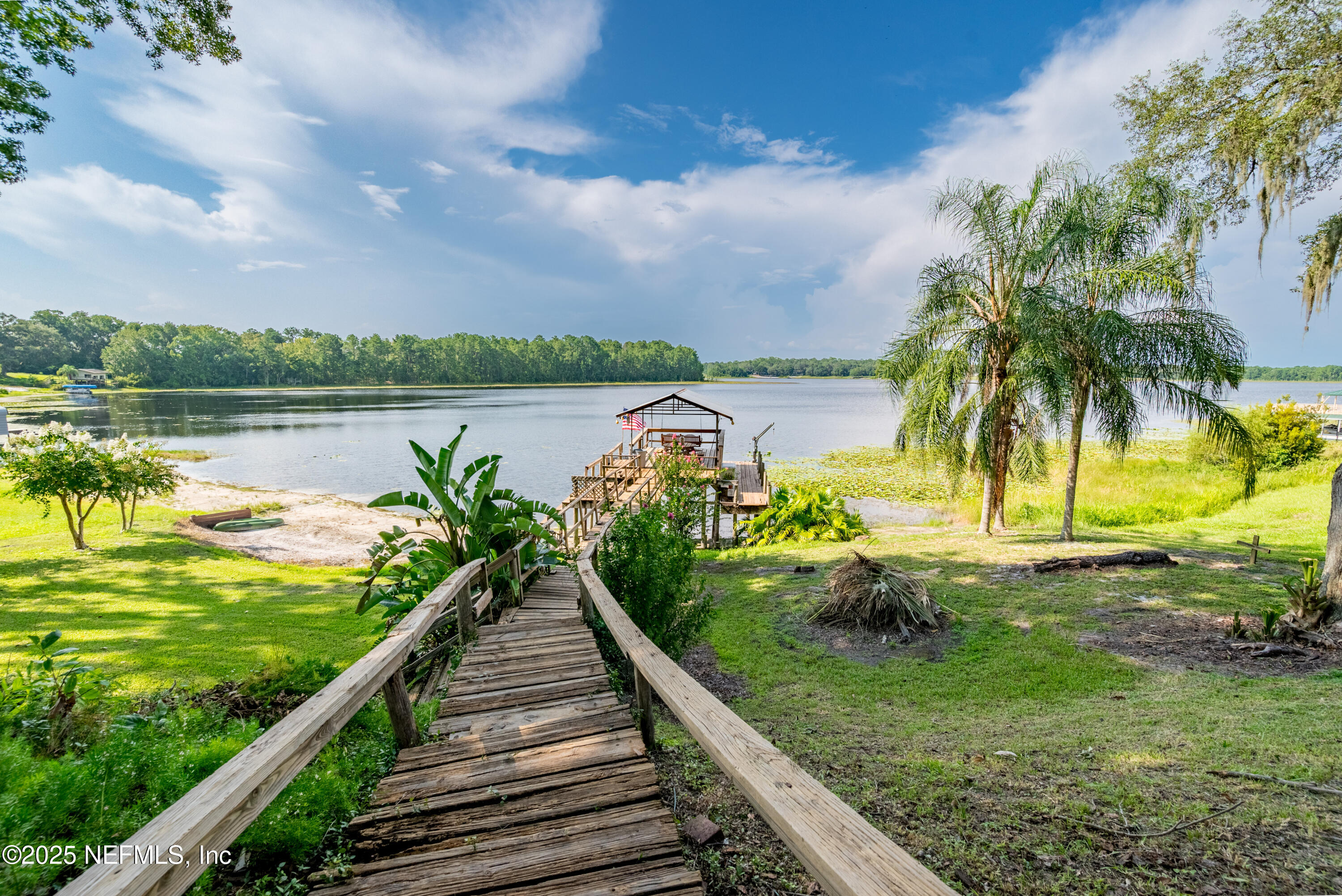 8166 Alderman Road Melrose, FL 32666 - Photo 22 of 94 a view of a lake with a garden