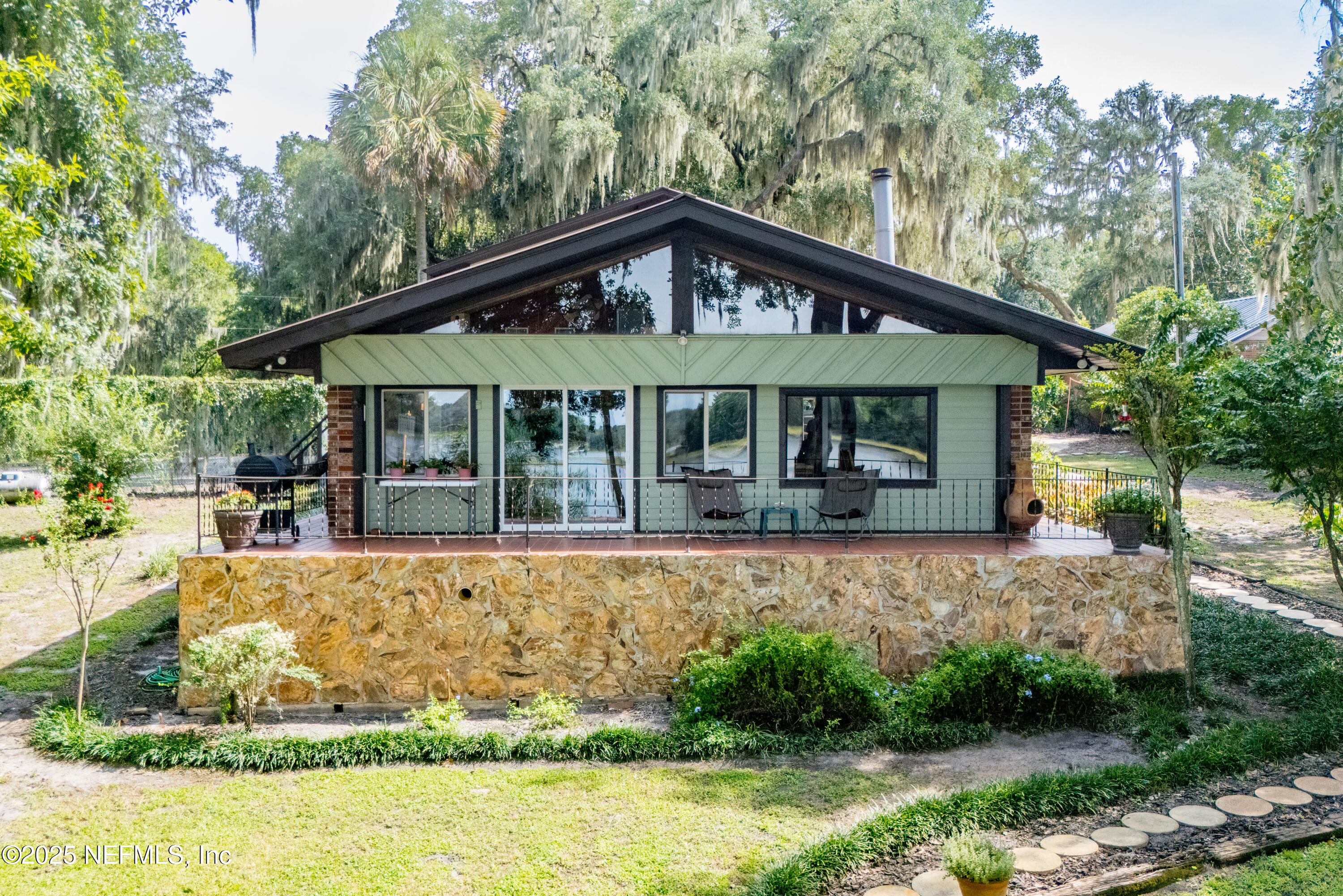 8166 Alderman Road Melrose, FL 32666 - Photo 35 of 94 a front view of a house with a yard table and chairs