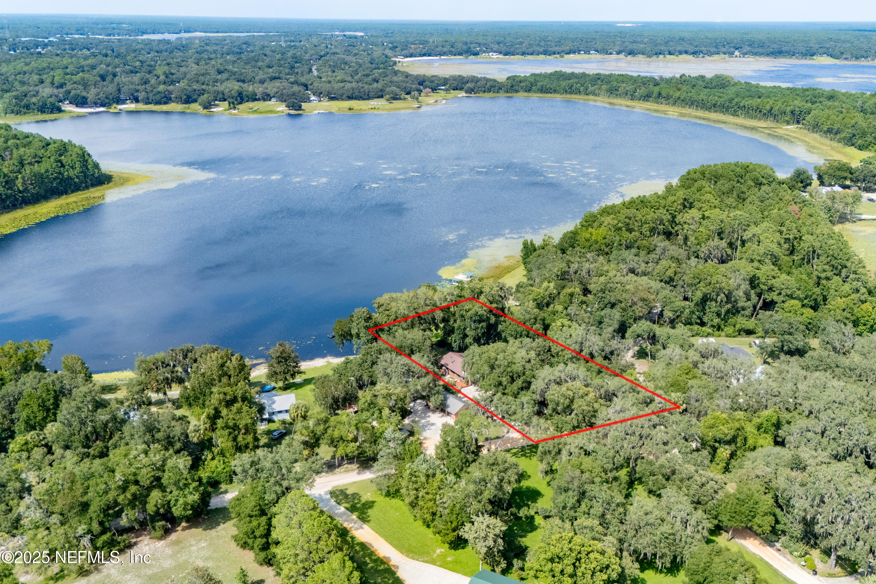 8166 Alderman Road Melrose, FL 32666 - Photo 38 of 94 an aerial view of a houses with a yard and lake view