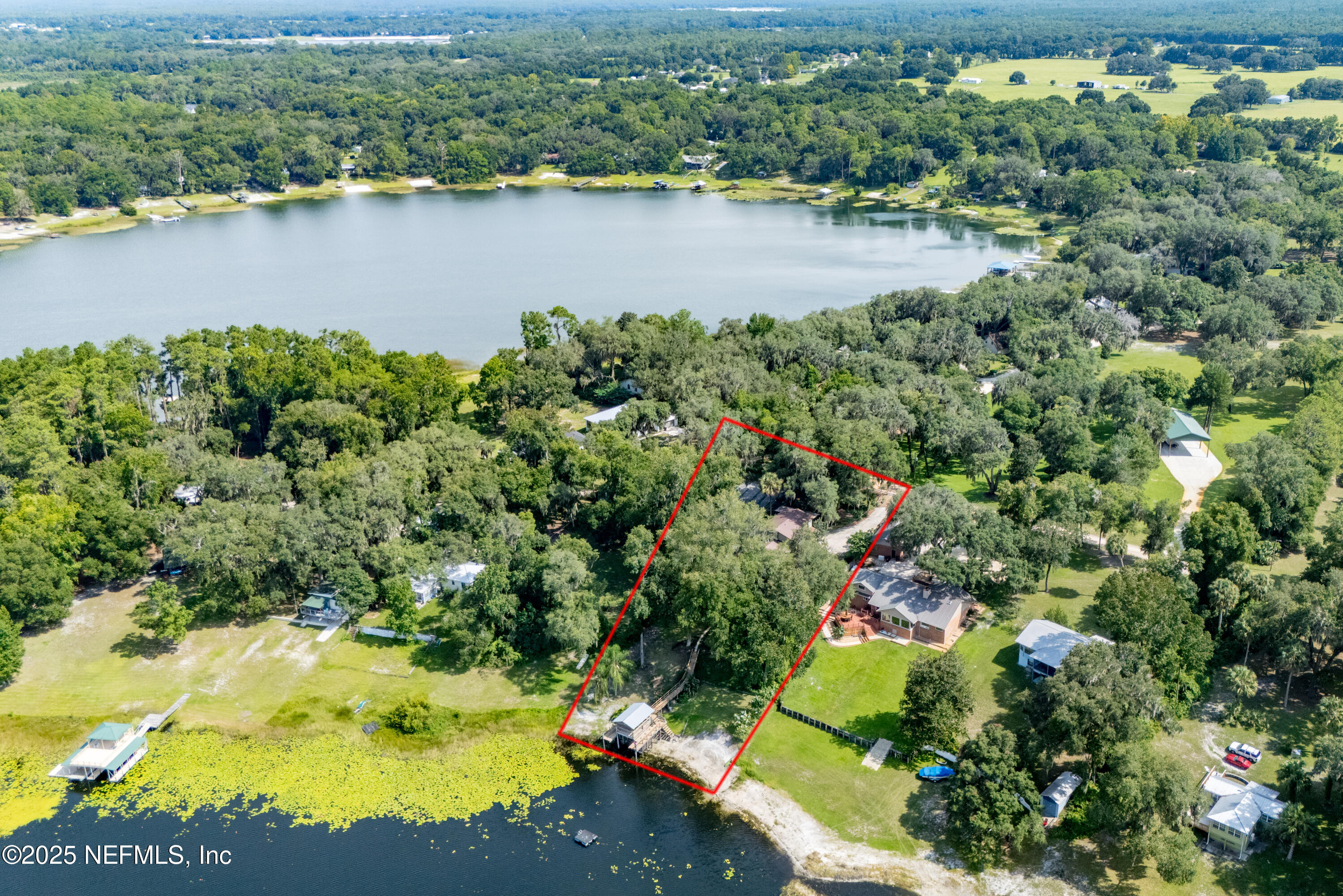 8166 Alderman Road Melrose, FL 32666 - Photo 42 of 94 an aerial view of residential houses with outdoor space and trees all around
